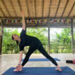 Yoga practitioner in an open-air Yoga Shala surrounded by nature